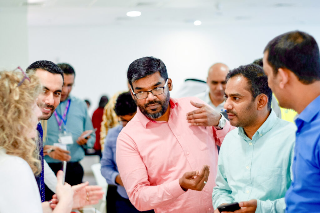 Group of people discussing a topic, with one man gesturing