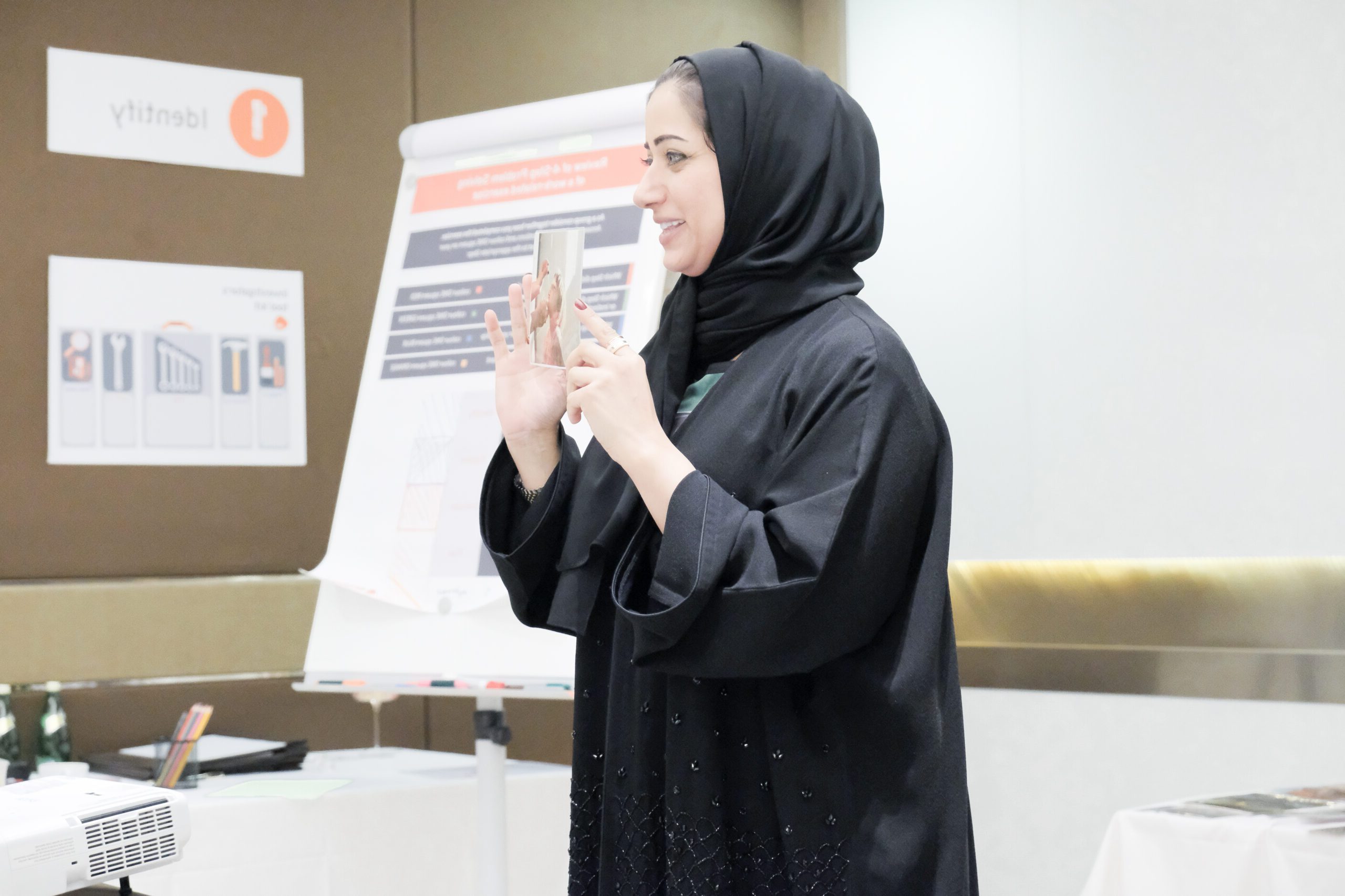 Woman in a classroom setting, sharing an image with her audience