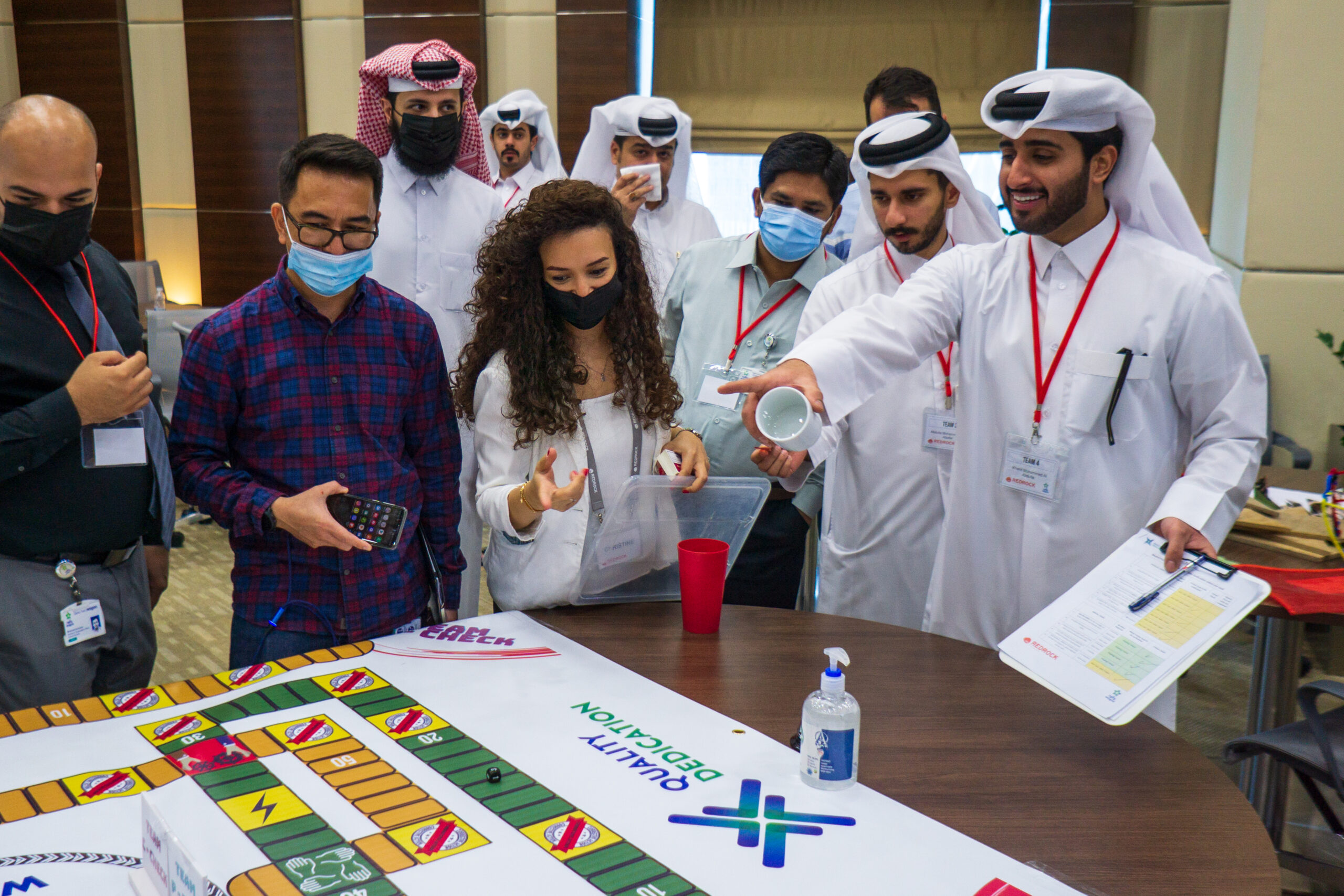 People gathered around a giant game board